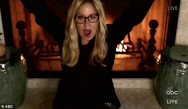 Fall feels: Christina Applegate looked cozy, bundled up in a black sweater by a roaring fireplace
