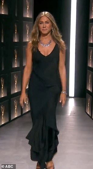 Golden girl: Aniston, 51, looked gorgeous in a low-cut black gown and silver jewelry