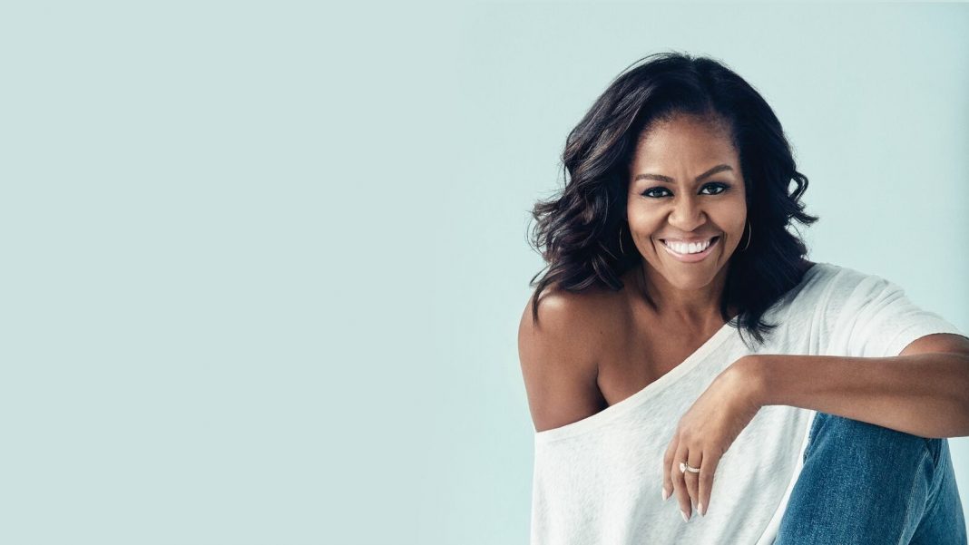 Michelle Obama smiling and sitting