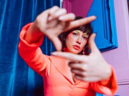 Gen Z’s Critical Message: “Hard Pass on Your Expectations” Young Gen Z woman looking through her own lens