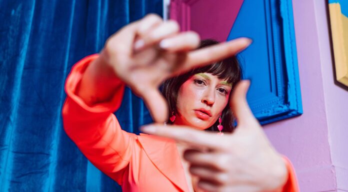 Gen Z’s Critical Message: “Hard Pass on Your Expectations” Young Gen Z woman looking through her own lens