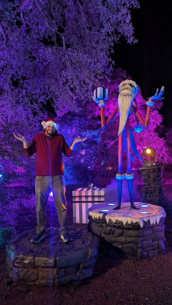 True Hollywood Talk's Austin editor Andrew Rossow poses with Santa Jack at Disney Tim Burton's Nightmare Before Christmas Light Trail in Austin, Texas at the LBJ Wildflower Center.