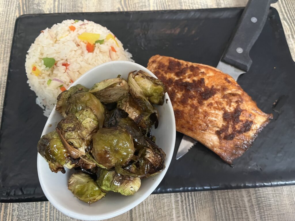 Baked Salmon, Charred Brussels Sprouts, and rice at Burgerology