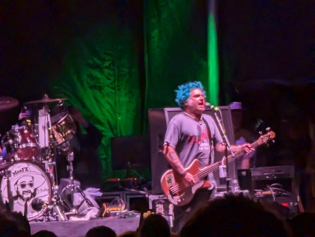 Mike Burkett founder of NOFX performs with blue hair on stage in Austin Texas in 2023 for Final Tour
