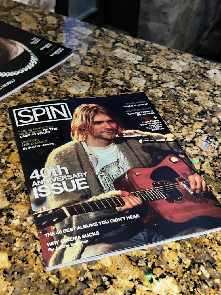 The 46th Anniversary print issue of SPIN Magazine laying out on a tiger-colored marble table in the SPIN x Tipify Lounge during SXSW 2026 in Austin, Texas.